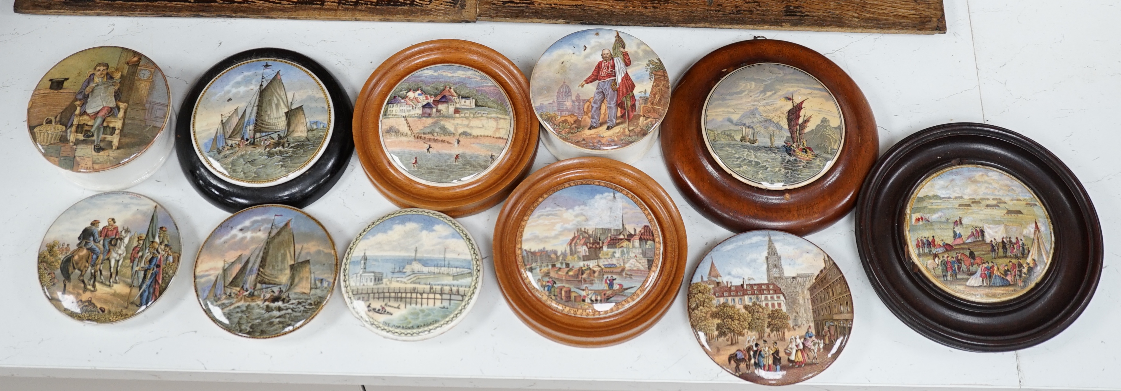 Eleven 19th century mostly framed pot lids including ‘The Ning Po River’, ‘Rifle Contest Wimbledon 1868’, ‘Vue De La Ville De Strasbourg Prise De Port’ etc. Condition - fair to good